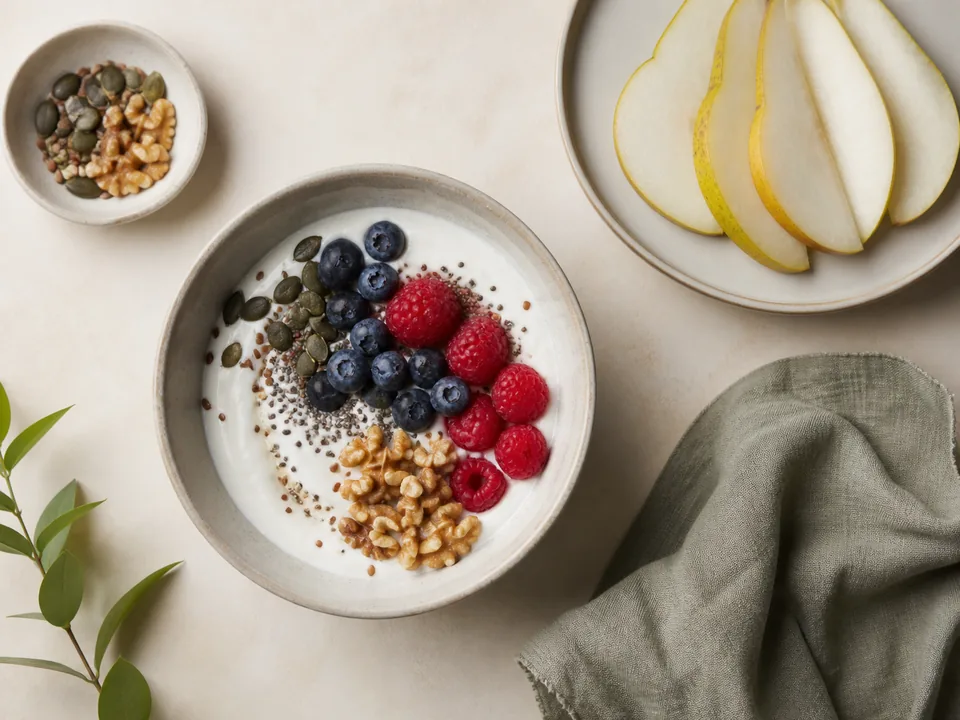 Balanced breakfast with yogurt, berries, seeds, walnuts and pear